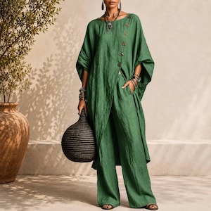 May include: A forest green two-piece set consisting of a long-sleeved tunic with a diagonal button placket and matching wide-leg trousers. The tunic features a round neckline and a side-slit hem, while the trousers have a relaxed, loose fit.