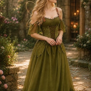 May include: An olive green floor-length dress featuring a corset-style bodice with brown leather-look straps, off-the-shoulder sheer sleeves, and a skirt with leaf-shaped hem detailing. The bodice includes lace trim and a crisscross lace-up front.