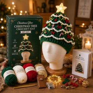 May include: A Christmas tree crochet hat DIY kit featuring a green hat with white trim, candy cane and bow embellishments, and a light-up star topper. Includes a box, instruction booklet, green, white, red, and gold yarn, a hook, and LED lights.