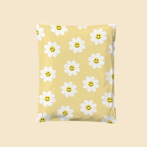 May include: A yellow poly mailer with a white daisy pattern and yellow smiley faces.