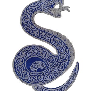 May include: A blue and silver embroidered snake patch. The snake is coiled with an open mouth and a forked tongue. The design features intricate scrollwork and a detailed pattern.