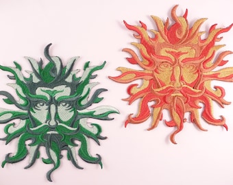 May include: Two embroidered patches depicting stylized faces of the sun and moon. The sun patch is orange and yellow, while the moon patch is green and white.