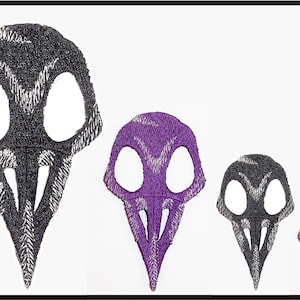 May include: Four embroidered bird skull patches in different sizes. The largest skull is black, the next two are black and purple, and the smallest is purple.