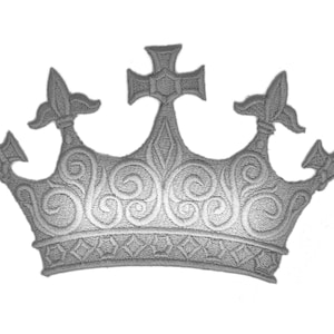 May include: A silver embroidered crown with a cross on top and ornate details.