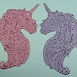 May include: Two embroidered iron-on patches of unicorns, one pink and one purple. The unicorns are facing each other with their heads tilted down.