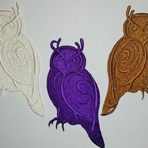 May include: Three embroidered owl patches in white, purple, and brown. Each owl has detailed stitching, with a stylized design. The owls are depicted in a side profile, with visible talons and a textured appearance.