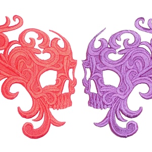 May include: Two embroidered skull patches, one in pink and one in purple, with intricate floral designs.