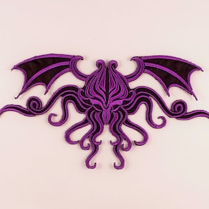 May include: Purple embroidered patch of Cthulhu, a fictional cosmic entity from the works of H.P. Lovecraft, with tentacles and wings.