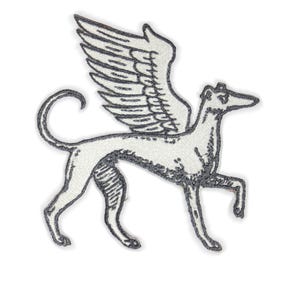 May include: Embroidered patch with a winged dog design. The patch shows a greyhound-like dog with large, detailed wings. The dog is white with grey outlining, and the wings are a darker grey. The patch is designed for clothing or accessories.