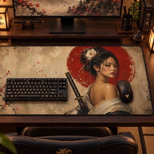 May include: A rectangular desk mat featuring a printed illustration of a person with dark hair adorned with a white flower, wearing a light-colored garment, positioned in front of a large red circle. A black mechanical keyboard and mouse sit on top.