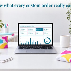 Sublimation bookkeeping spreadsheet annual dashboard open on a laptop on a desk