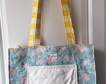 Handmade quilted tote bag with vintage embroidered linen pocket.