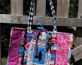 Handmade handbag quilted tote with vintage doilie trim and embroidered front pocket.