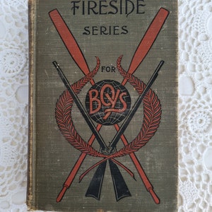 May include: A vintage green book with the title "Fireside Series for Boys" in black lettering. The cover features a red and black illustration of crossed oars and rifles with a laurel wreath and a globe.