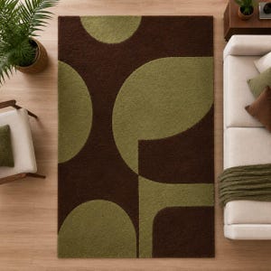 May include: A rectangular area rug featuring a bold, large-scale geometric pattern with overlapping circular and curved shapes in deep chocolate brown and muted olive green. The rug has a dense, textured pile surface with clean, rounded edges.