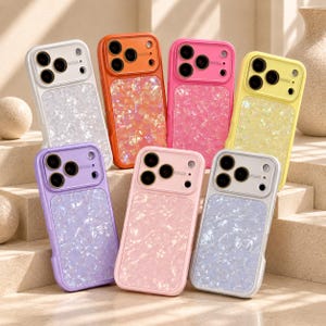 May include: A collection of seven smartphone cases featuring a camera lens cutout area and a lower section with a shimmering, iridescent, crushed shell-like texture. The cases are available in white, orange, pink, yellow, purple, and light pink colors.