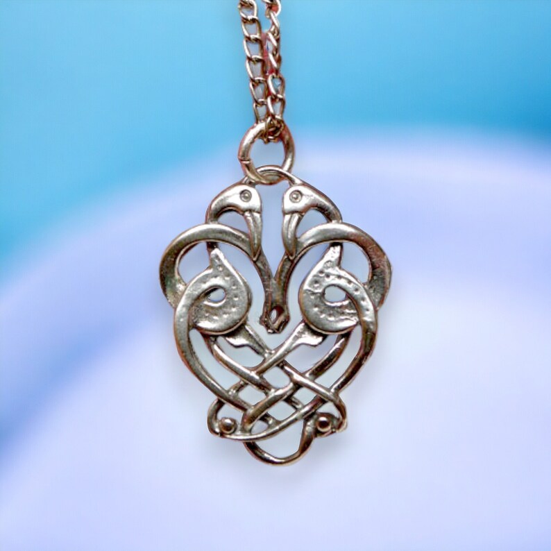 Sterling Silver Entwined Celtic Love Birds Pendant | Celtic Crane Zoomorph Jewelry - Celebrate love, unity, and timeless connection with this exquisite Entwined Celtic Love Birds Pendant, inspired by traditional Celtic zoomorphic art. Featuring two graceful cranes entwined in an elegant dance, this piece symbolizes devotion, partnership, and the deep bonds that tie souls together.