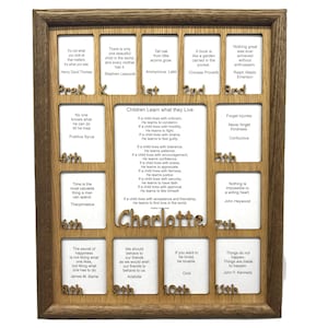May include: Wooden framed wall art with a series of quotes and sayings, including "Children Learn What They Live." The frame has a natural wood grain finish. The name "Charlotte" is displayed in the center.