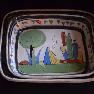 May include: A set of three ceramic nesting dishes with a hand-painted design featuring a green tree, a blue and yellow tent, and a cactus in shades of green, blue, and orange.