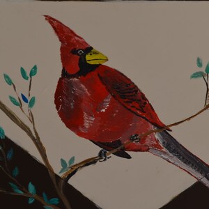 May include: A red cardinal bird with a yellow beak perched on a branch with green leaves. The bird is painted in a realistic style.