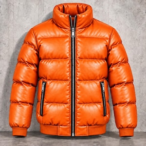 May include: A bright orange puffer jacket featuring a high collar, a full-length black front zip, and two vertical zipped pockets on the sides. The jacket has a quilted design with horizontal baffles and ribbed cuffs at the sleeves.
