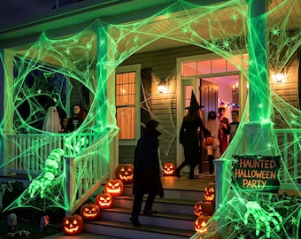 May include: A house porch decorated with glowing green spider webs, numerous lit jack-o'-lanterns on the steps, and a sign reading HAUNTED HALLOWEEN PARTY. Figures in costumes are visible near the entrance under a crescent moon in the night sky.