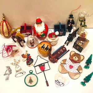 May include: A collection of vintage Christmas ornaments, including a Santa Claus, a sleigh, a bell, a wooden bear, a house, a star, and a variety of other festive decorations.