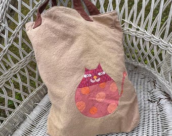 Bolso de lona vintage con diseño de gato pintado con arte popular, bolso de playa reutilizable con diseño de gatito sonriente, antropomórfico y gordo, de lunares rosa y naranja.