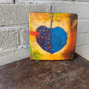 Base para panela de cerâmica com formato de coração azul pintado à mão, formas abstratas e policromadas (como encontrado)