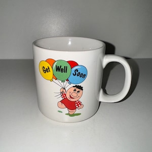 Taza de café vintage de los años 80 con diseño de "Que te mejores pronto", dibujo de un niño con globos, regalo alentador, taza para beber de Russ Berrie EUC