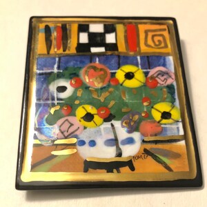 May include: A square ceramic tile with a gold border and a colorful abstract painting of flowers in a vase. The painting is in a style reminiscent of modern art. The tile is signed "Tome"