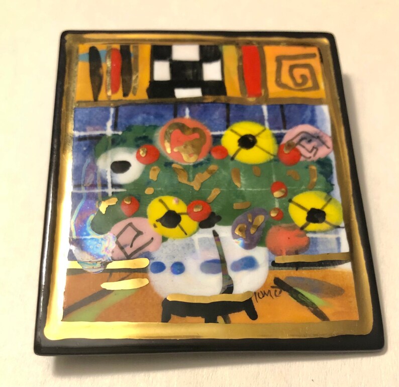 May include: A square ceramic tile with a gold border and a colorful abstract painting of flowers in a vase. The painting is in a style reminiscent of modern art. The tile is signed "Tome"