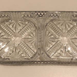May include: A silver serving tray with two clear glass dishes. The dishes have a cut glass design and are ideal for serving snacks or appetizers.