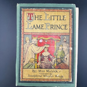 May include: A vintage copy of "The Little Lame Prince" book. The cover features a green border and a detailed illustration of a coronation. The title is displayed in ornate lettering, with the author's and illustrator's names below the illustration.