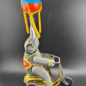 Vintage Schylling Elephant on Bike Wind Up Toy Twirling Ball w Tassels Chinese Lithographed Tin Toy As Is