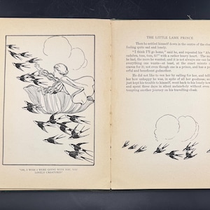 May include: An illustrated book spread from "The Little Lame Prince." The left page shows a black and white illustration of a figure on a flower, with birds flying around. The right page has text and a drawing of birds.