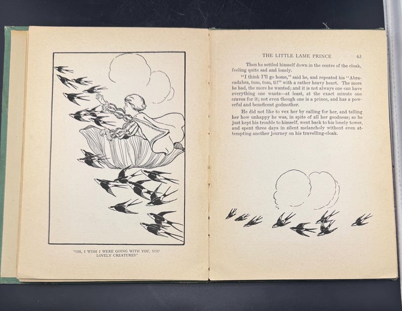 May include: An illustrated book spread from "The Little Lame Prince." The left page shows a black and white illustration of a figure on a flower, with birds flying around. The right page has text and a drawing of birds.