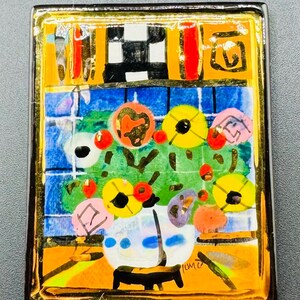 May include: A colorful, abstract painting of a vase of flowers in a gold frame. The flowers are red, yellow, and pink, and the vase is white with blue accents. The background is a blue and green tiled wall. The painting is signed "Tume" in the lower right corner.