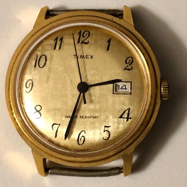 Relógio Timex Marlin vintage raro, com base dourada, aro e fundo em aço inoxidável, resistente à poeira e à água, número de data 2656102575. No estado em que se encontra.