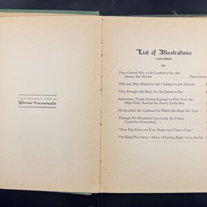 May include: Open book with a green cover, showing a list of illustrations. The text includes titles such as "They Carried Him to Be Looked at by the Queen, His Mother" and "Milk and Bun Feasts for the Children in the Schools." Copyright 1916 by Whitman Publishing Co.