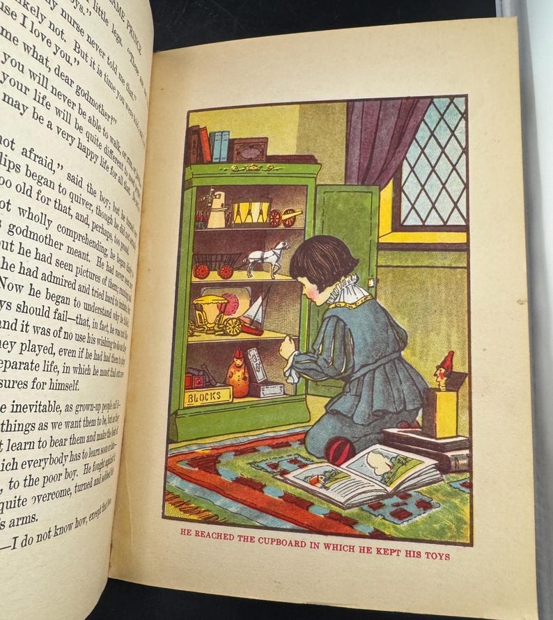 May include: A vintage book illustration depicts a child kneeling before a green cupboard full of toys. The text below reads, "HE REACHED THE CUPBOARD IN WHICH HE KEPT HIS TOYS." The scene is set in a room with a patterned rug.