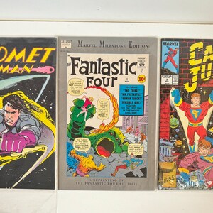 May include: Three comic books featuring the characters Comet Man, Fantastic Four, and Captain Justice. The covers are colourful and feature action-packed scenes.