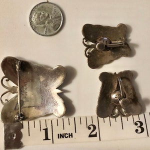 May include: Three silver butterfly earrings with a sterling silver stamp. The earrings are approximately 1 inch in size.