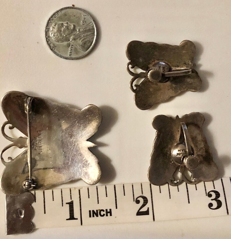 May include: Three silver butterfly earrings with a sterling silver stamp. The earrings are approximately 1 inch in size.
