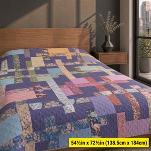 May include: A quilt featuring a patchwork design of rectangular blocks in shades of purple, pink, blue, and cream with floral patterns and a diamond-stitched texture. The quilt measures 138.5 cm by 184 cm as indicated by the text overlay.