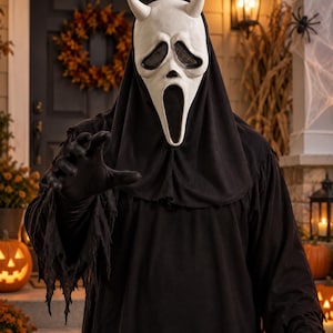 May include: A white devil-horned mask with black mesh eye coverings and an elongated open mouth, paired with a black hooded robe featuring frayed, tattered sleeve edges. The mask has two small, pointed horns on the top and a smooth, pale surface.