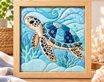 May include: A square framed fabric wall art piece featuring a quilted sea turtle swimming through blue waves. The turtle has a tan head and flippers with dark spots, and a shell composed of various blue patterned fabric patches. Light blue coral sits below.