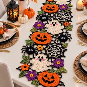 May include: A rectangular crochet table runner featuring a repeating Halloween pattern of orange jack-o'-lanterns, white ghosts with pink cheeks, black spiders with white eyes, white spiderwebs, purple flowers, and green leaves on a black mesh base.