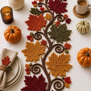 May include: A crochet table runner featuring a central brown vine with curling tendrils and various maple leaves in shades of red, orange, yellow, and dark green. The runner is arranged vertically with detailed textured stitches on each leaf.