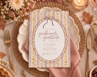 May include: A rectangular invitation card featuring a vertical striped pattern in light purple and yellow with floral accents. The center displays an oval frame with the text: You're invited to girlfriends + gratitude, 11.21.2026, 1-5 PM, 1234 Thankful Lane, Turkey, GF 56789, rsvp by 10.31.2026.